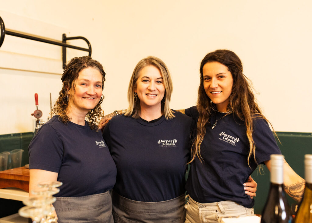 Three bartenders smiling at the camera at a Business After Hours event with The Greater Vancouver Chamber of Commerce