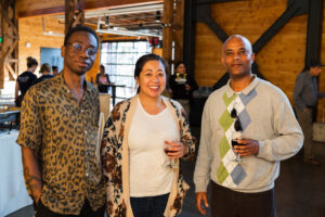 Three smiling guests looking at the camera at a networking event held at The Redd on Salmon in Portland, OR.